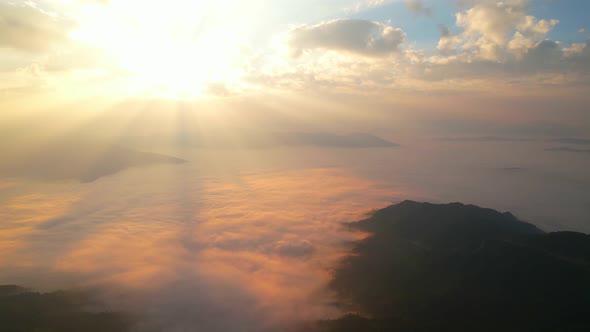 Aerial view from drone, Epic sunbeam over clouds mountains.