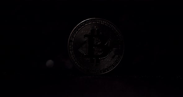 New Virtual Currency with One Silver Bitcoin Close Up on Black Background