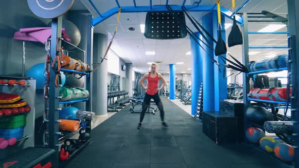 Attractive fit woman in gym. Beautiful young woman working out in the fitness studio