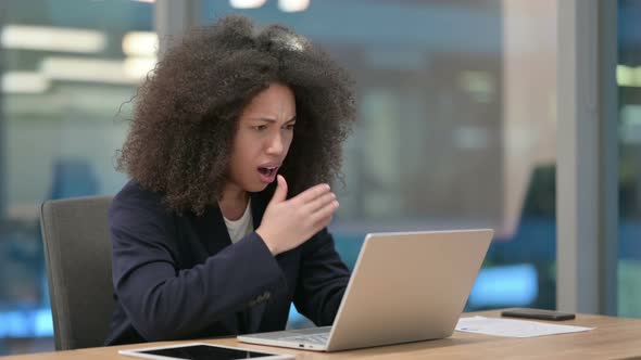 African Businesswoman with Laptop Reacting to Loss