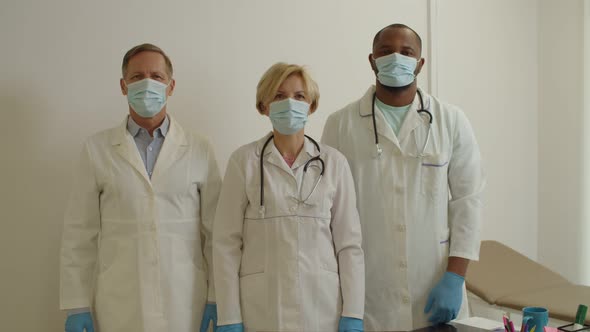 Confident Diverse Multicultural Healthcare Workers with Arms Crossed Posing at Medical Clinic