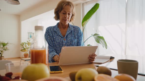 beautiful senior woman spending time in her house