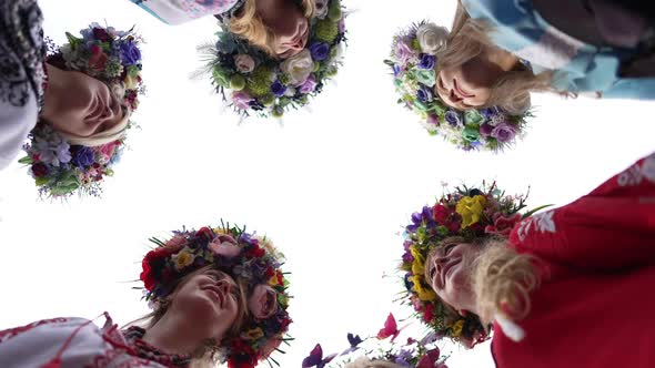 Bottom Angle View Group of Ukrainian Beautiful Women in Head Wreathes and National Clothes Walking