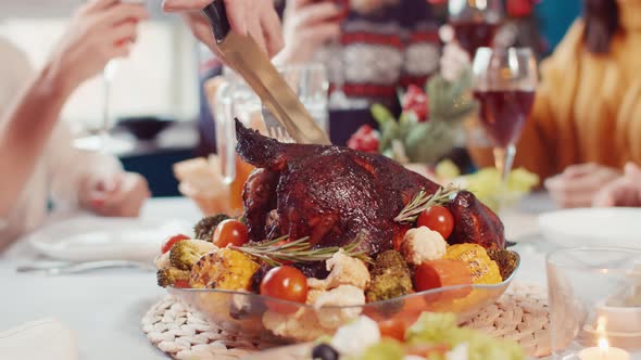 Father's Men's Hands Cut Meat From Thigh of Chicken Baked Chicken with Vegetables, While Clinking