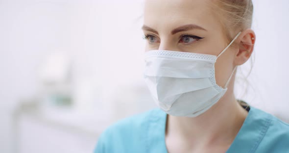 Female Doctor Wearing Protective Mask at Healthcare Clinic
