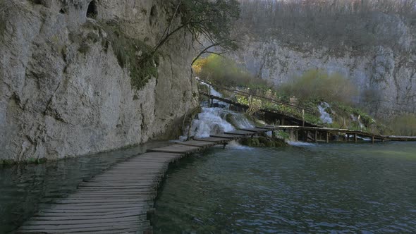 Wooden boardwalk over waterfall at Plitvice Park