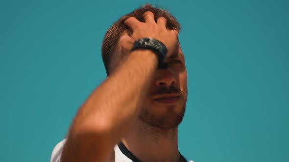 Large Portrait of a Young Guy Fixing His Hair