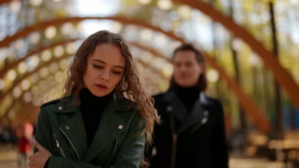 Woman is Walking in Park and Handsome Man is Following Her Date and Acquaintance