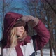 A Happy Girl in Mittens Looks in the Distance on a Frosty Winter Day - VideoHive Item for Sale