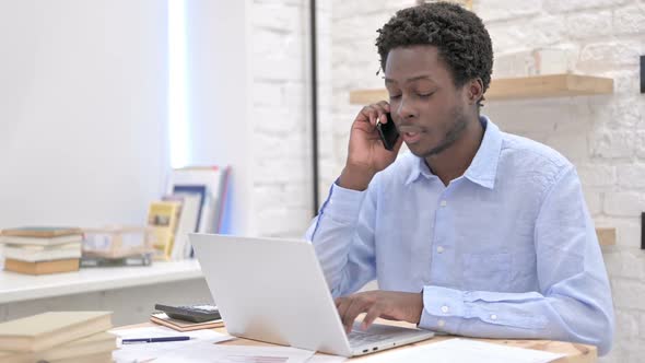 Working African Man Talking on Phone