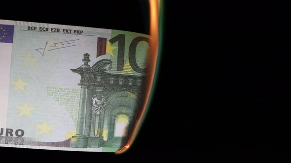 burning hundred euros on a black background. concept of combustion savings