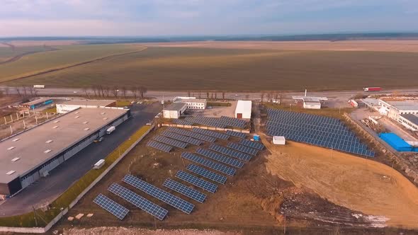 Solar farm on the field. Industry of clean energy production. Sunny batteries on the nature backgrou