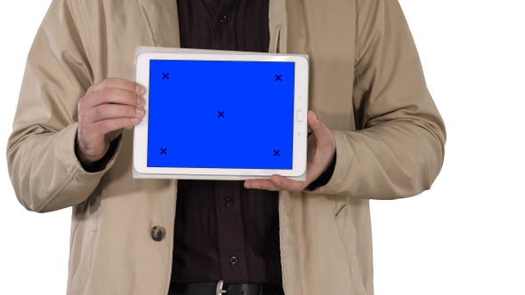 Male hands holding tablet with blue screen mockup on white