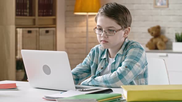 Schoolboy Working on Laptop