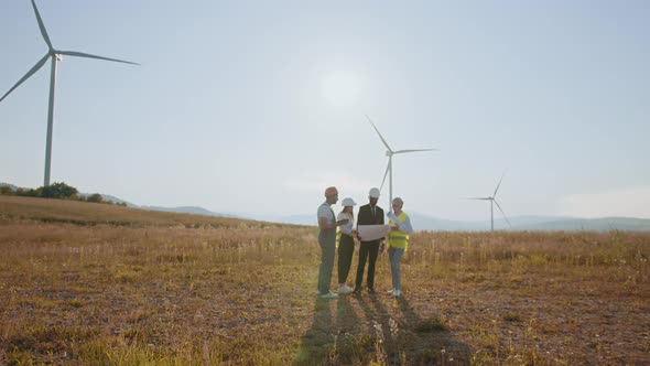 Holding a Plan on Site at Wind Turbines Field or Farm Clean Energy Source