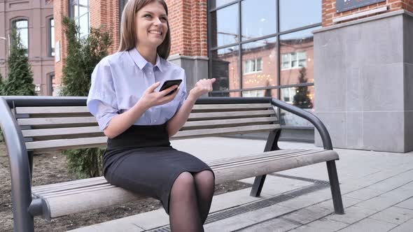 Woman Celebrating Success while Outdoor Using Smartphone