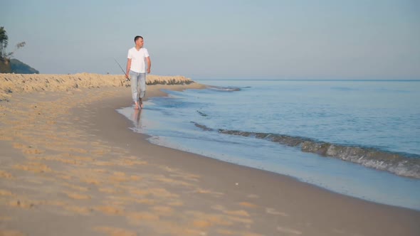 Man with Fishing Rod on Beach