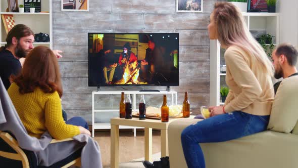 Rear View of Blonde Woman with Her Friends Watching a Tv Show