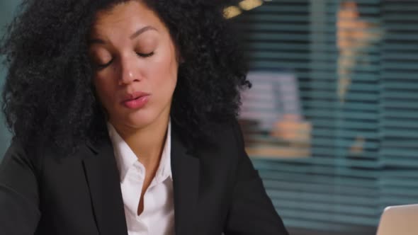 Portrait of African American Woman Makes an Online Purchase Using Credit Card and Smartphone