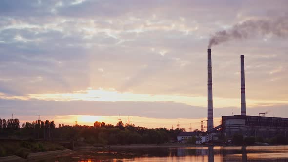 Factory in the countryside. Industrial zone near the river in the morning.