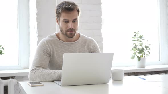 Businessman Working On Laptop in Office