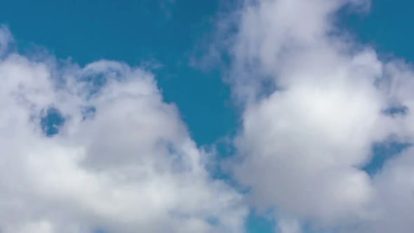 Time lapse of moving clouds in blue sky