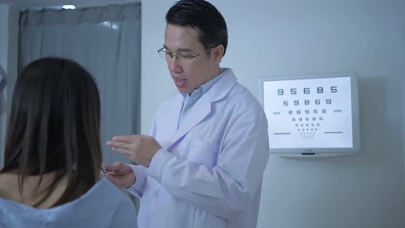 Optical shop concept. The ophthalmologist is measuring the customer's eyes. 4k Resolution.