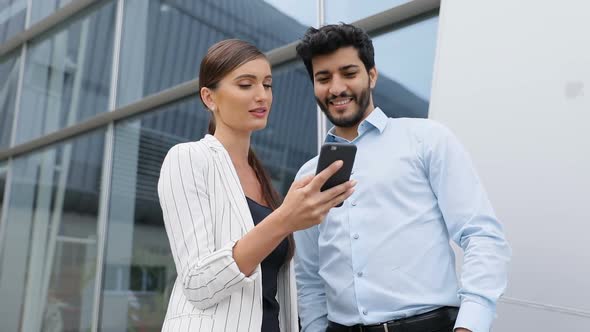 Business People Using Phone Near Office On Street