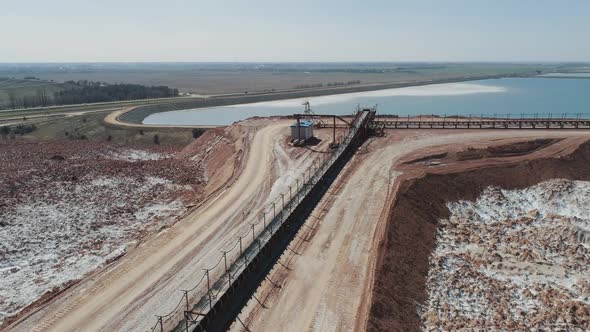 Mining of Potash Salt Conveyor Line in Salt Pits Aerial View of Salt Piles and Industrial Quarries