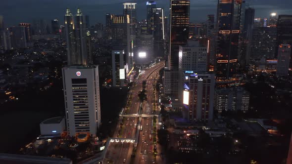 Aerial Shot of Traffic on the Multi Lane Highway Through the Modern City Center in the Night in