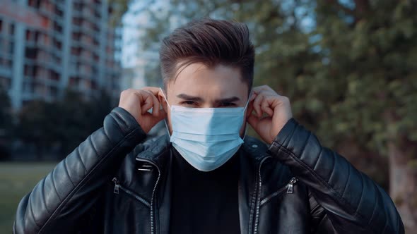 Portrait of a Short-bearded Young Man Wearing a Protective Mask. The Concept of Health and Safety