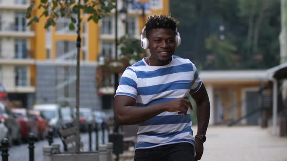 African American Man in Headphone Enjoying Afrobeat