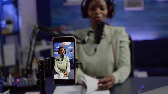 Focused Shot on Smartphone Recording African Blogger Woman Talking