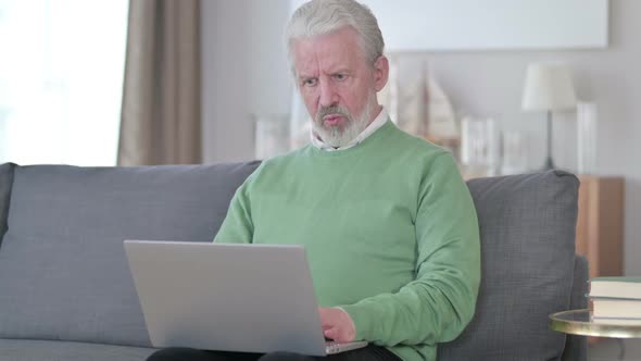 Sad Old Man Having Failure on Laptop at Home