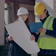 Supervisor Holding Blueprint While Discussing with Worker - VideoHive Item for Sale