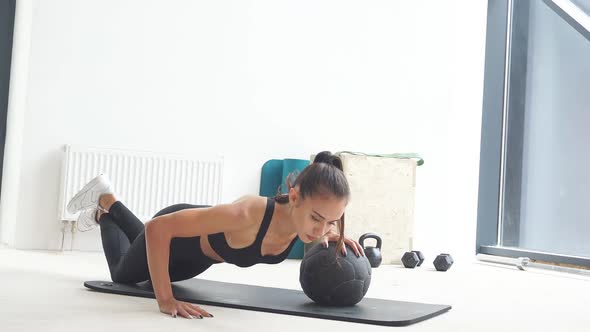 Attractive Caucasian Girl in Sportswear Do Push Up with Ball.