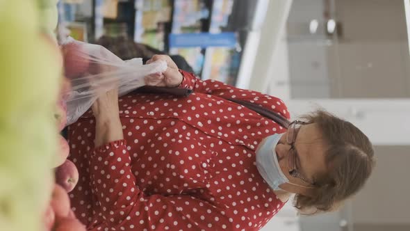 Senior Woman Buying Apples in a Grocery