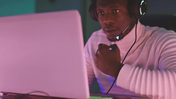 Black Creative Man, with Illuminated Headset Working Late at Night