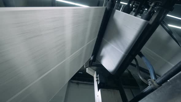 Rolling Machine Is Processing Paper Web. Newspaper Printing at a Factory