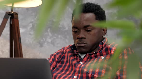 Adult African American Man Freelancer Works for Laptop Typing Text on Keyboard