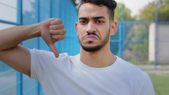 Upset Sad Athlete Shows Thumbs Down Gesture of Denial Dislike Disagrees with Results Soccer Match