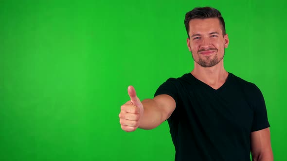 Young Handsome Caucasian Man Shows Thumb Up on Agreement - Green Screen - Studio