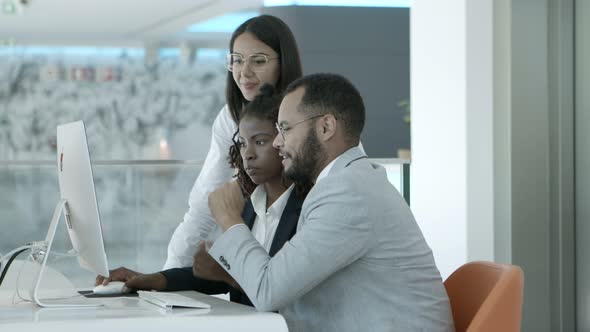 Multiethnic Colleagues Using Desktop Computer