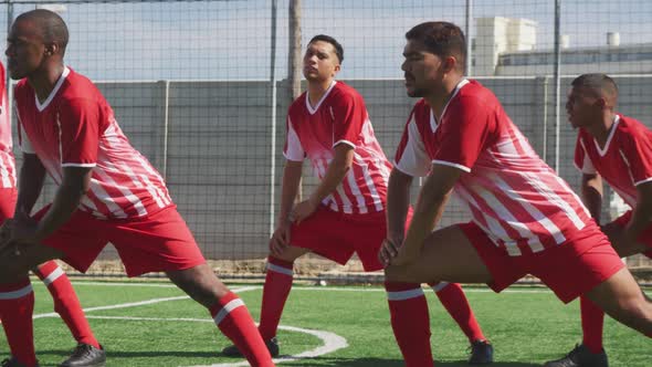 Soccer players stretching on field