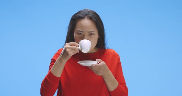 Young Woman Drinking Coffee