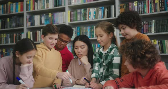 Blonde Girl Draws for Teacher Surrounded By Schoolmates