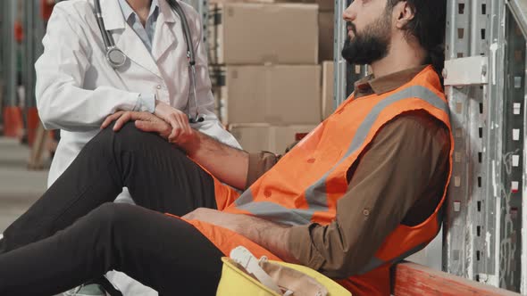 Female Doctor Examining Man in Workplace