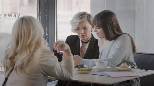 Four Female Friends in a Modern Cafe