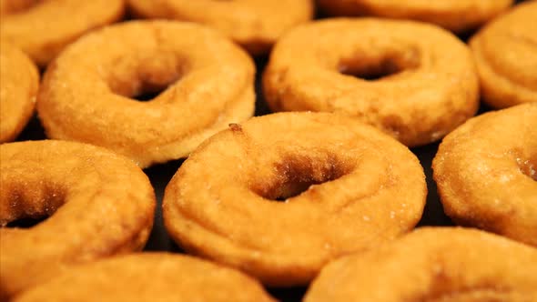 A lot of doughnuts in on the black desk