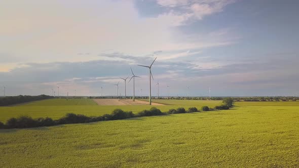 Aerial view of wind turbine generators in field producing clean ecological electricity.